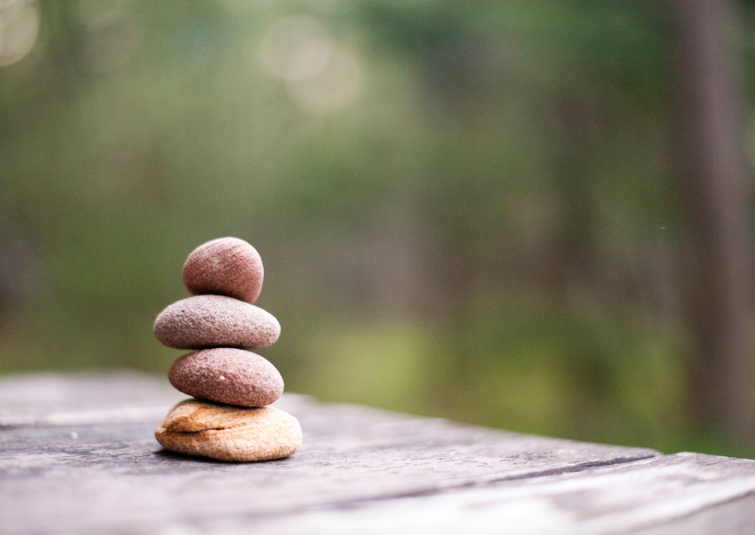 A close-up photo of four rocks, stacked on top of one another.