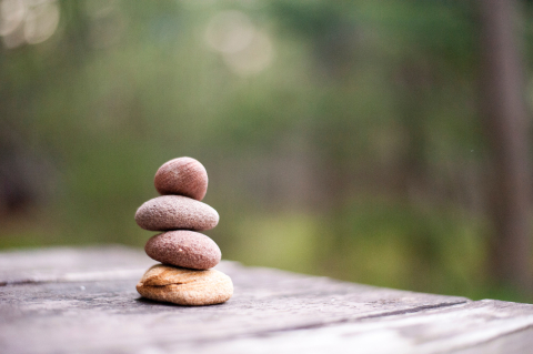 A close-up photo of four rocks, stacked on top of one another.